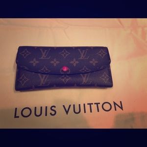 Louis Vuitton wallet with dark pink accents.